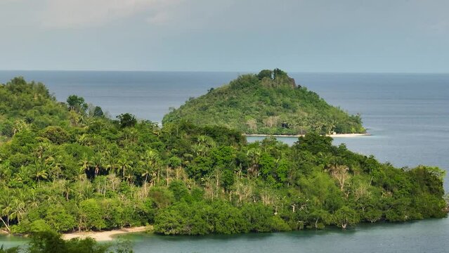 Islands with green plants and trees. Beach and blue sea in Once Islas. Zamboanga, Philippines.
