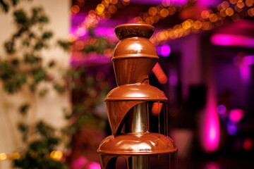 Liquid chocolate fountain at an event or celebration.