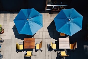 An alluring flat lay showcasing an outdoor café, brimming with umbrellas and seating, observed from an aerial perspective, illustrating a lively and inviting ambiance.