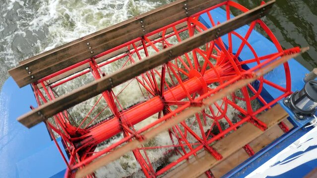 Paddle wheels of a paddle steamer ship on a river