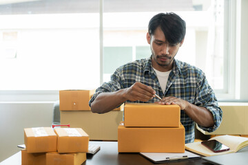 African American male manager who packs parcels in warehouse before sending orders to customers of online store, SME business concept