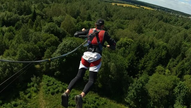 jump from a height, jump from a tower with belay, a guy jumps from a height with belay, a man jumps from a tower with belay, 
Slow motion