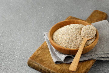 rye bran in bowl and in spoon on gray table
