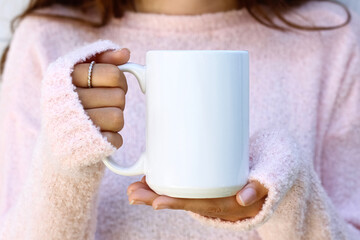 Girl is holding blank large white porcelain mug in hands and soft pink sweater. Blank 15 oz big ceramic cup

