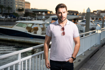 Fototapeta premium Urban style guy with casual clothes walk in Tampa city. Portrait of attractive man with casual clothes walk in American city. Handsome young man in an urban fashion lifestyle walking in the street.