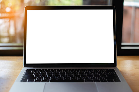 Laptop with blank screen on table.