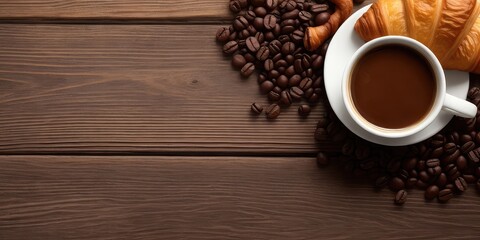 Croissant, mug of coffee and coffee beans on a wooden table, top view, copy space on the left