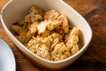 Deep fried cauliflower in a plate on a wooden background. vegetarian food