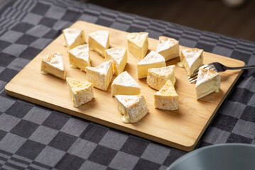 French cheeses, Camembert cheese, Brie on a wooden cutting board