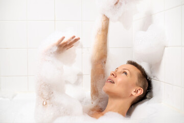 Woman with short hair immersed in a calming bubble bath