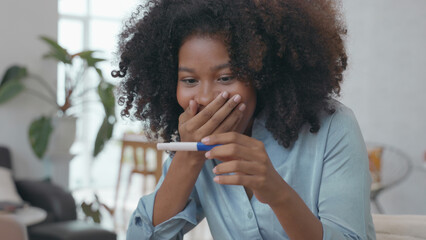 Fototapeta na wymiar Happy African Woman Celebrating Positive Pregnancy Test Result