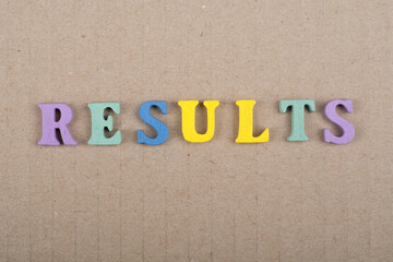 RESULTS word on wooden background composed from colorful abc alphabet block wooden letters, copy space for ad text. Learning english concept.