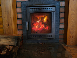 Oven in a traditional country cottage, fire in a cast-iron stove