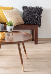 Modern Living Room Featuring a Nordic Wooden Round Coffee Table Adorned with Modern Ceramic Plant...