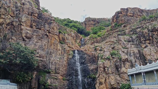 A beauty of charming natural attractions of waterfalls bisect the rock face