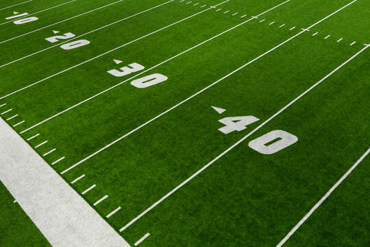 football field green artificial turf with yard lines and numbers