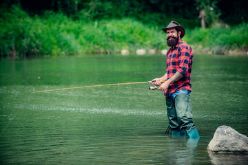 Fisherman caught a fish. Man fishing on river.