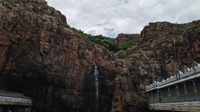 A beautiful view of a cascading holy waterfall from the top of the mountain