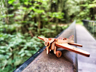 Vintage toy wooden airplane with stars on wing in nature. Plane crash, breakdown. Old Soviet glider from USSR of Soviet Union. Military aircraft from World War II and the Great Patriotic War of Russia
