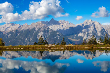 The Kaltwassersee lake in Seefeld/Tyrol. The mountains and the clouds are reflected in the cold clear water of the mountain lake