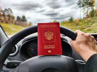Russian passport in hand of driver woman. Russian cars banned for entering in Europe. Russian...