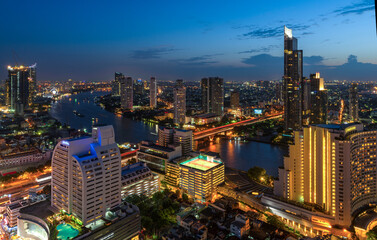 Fototapeta na wymiar Aerial City view of Bangkok city and subway station Thailand Bangkok skyline and skyscraper with light trails on Sathorn Road center of business in Bangkok downtown. Bangkok Thailand