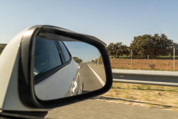 Fototapeta na wymiar car rearview mirror looking back to be able to place another image empty image image white hole