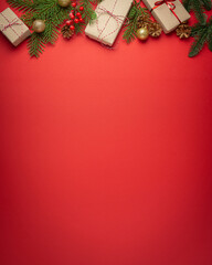 Christmas or New Year celebration red paper festive background with decoration fir tree, wrapped...