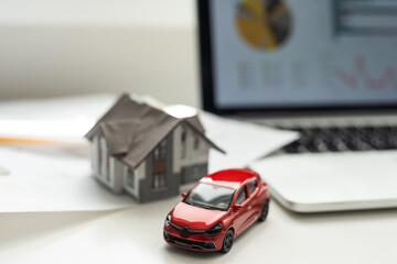 House, red miniature car and money