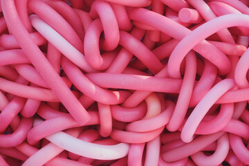 Pink rubber cords as a background, close-up, top view