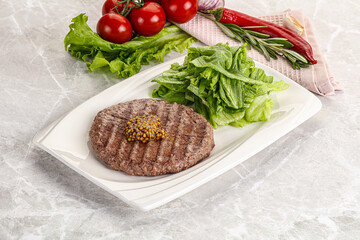 Frilled beef burger cutlet with iceberg