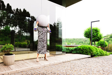 High fashion photo of a beautiful elegant young woman in a pretty zebra print dress posing outdoor.