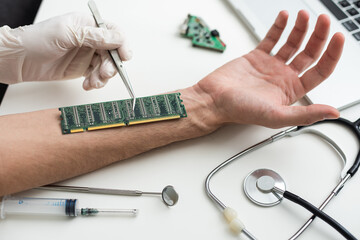 The cosmetic surgeon made a small incision to insert the chip into the patient's arm. Biotechnology, electronic documents and technological future concept. Bionic chip. Biohacking