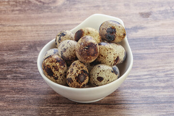 Raw quail eggs heap in the bowl