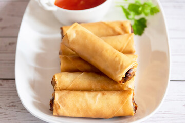 Deep fried spring rolls with pork and shrimp with sweet chili dipping sauce.