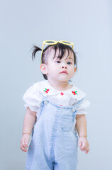 Asian girl, 1 year old,Cute asian kid in the house,Image of Asian child posing on blue background