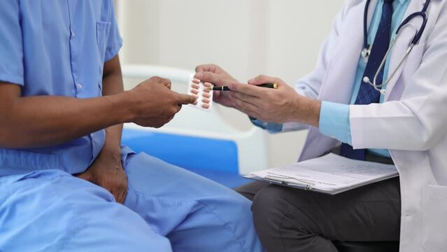 Doctor gives medication advice to a male patient with symptoms of sexual dysfunction, Male health problems. Health consultants and disease treatment from specialized doctors in the hospital.