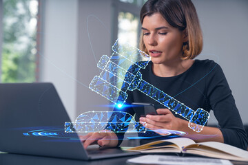 Pensive attractive beautiful businesswoman working on laptop, talking on phone at office workplace in background. Flying legal icons. Concept of law and order.