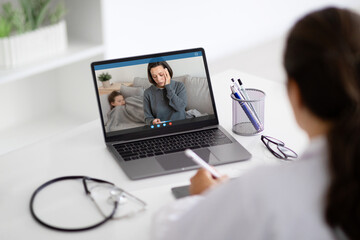 Back view woman doctor have video call with family patients