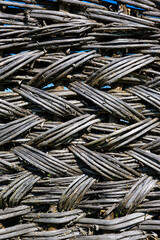 vertical background in the form of a fence woven from branches.