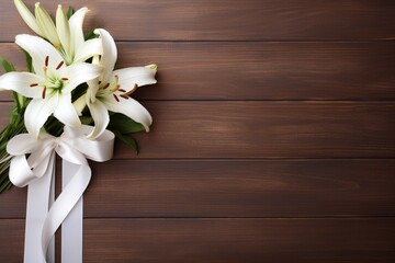 White lily flowers on wooden background. Top view with copy space.Funeral Concept