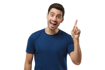 Portrait of young handsome smiling man in blue t-shirt, pointing his finger in eureka sign, having great idea, understanding solution