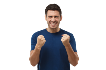 Young man showing white teeth while screaming with joy, holding hands in gesture of winner, looking extremely happy