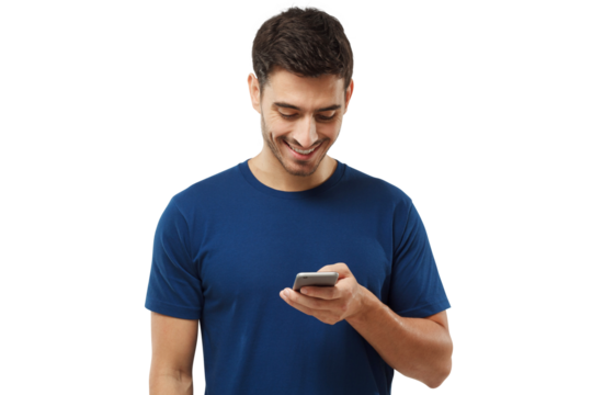 Young man standing in blue t-shirt, looking at phone, surfing web and smiling while browsing content