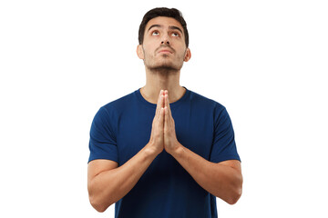 Religious young man holding palms together, looking upwards, praying