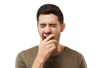 Sleepy young man yawning, waking up, closing his mouth with hand