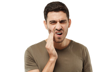 Young man feeling tooth pain, holding his cheek with hand, suffering from toothache