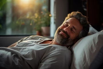 Foto op Plexiglas A Caucasiam man peacefully sleeps on a bed dreaming happily  © fotoworld
