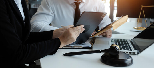 Male lawyer working with contract papers and wooden gavel on tabel in courtroom. justice and law ,attorney, court judge, concept.