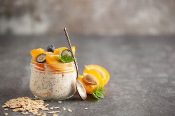 Healthy diet breakfast. Overnight oatmeal with chia seeds, bananas, apricot and blueberry in a...